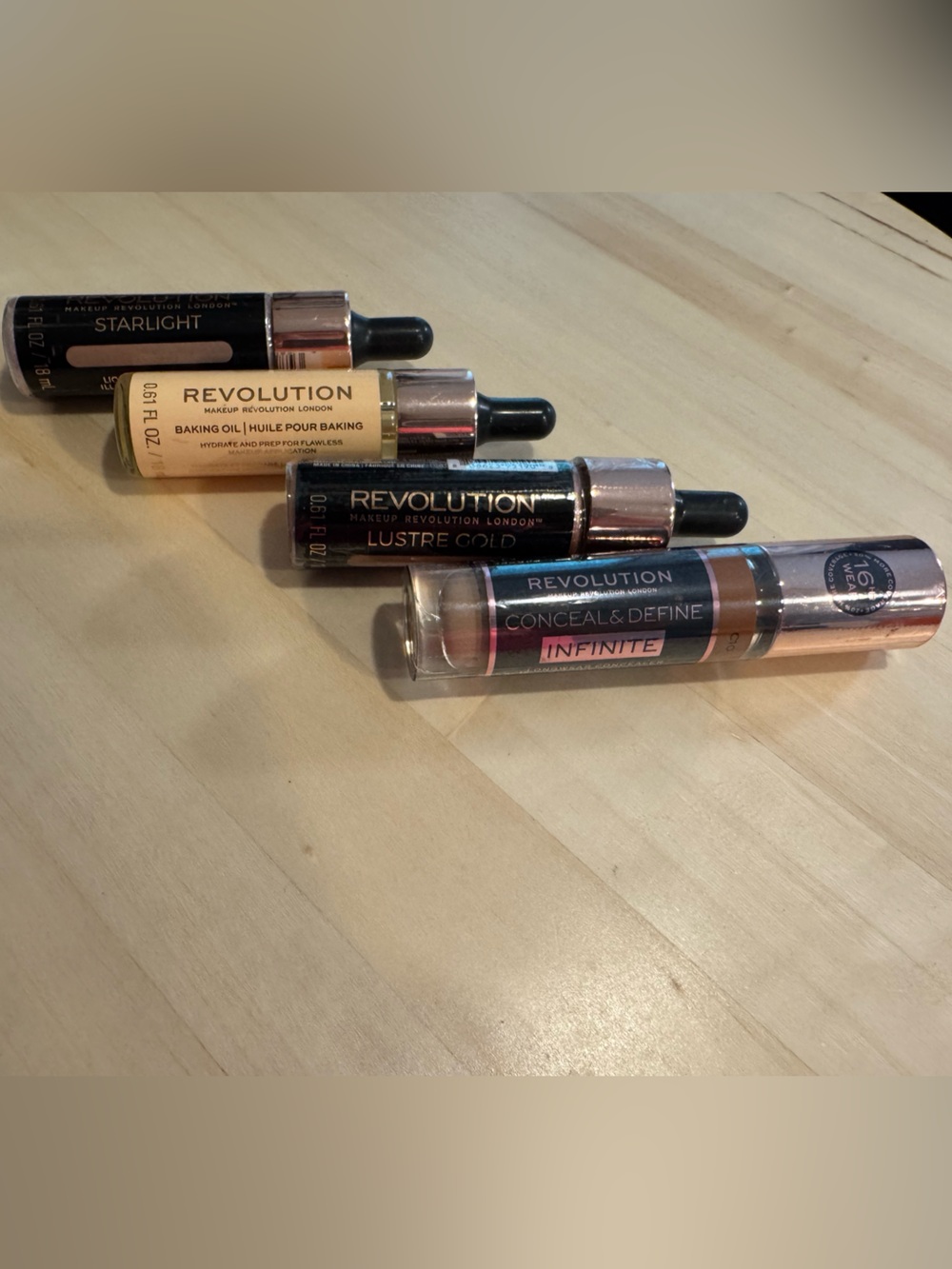 Revolution Concealer, Liquid Highlighters, and Baking Oil. All 4 included. NWT